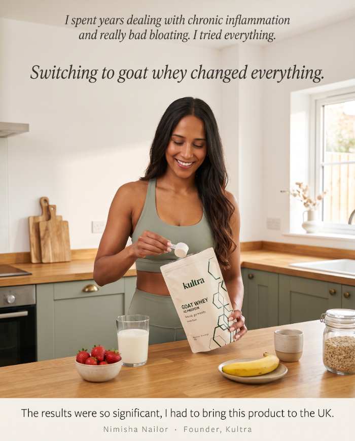 A woman in a kitchen holding a bag of Kultra Goat Whey powder, with text overlays at the top and bottom praising the product's benefits. The scene includes a glass of milk, strawberries, a banana, and a jar of oats on a wooden countertop.